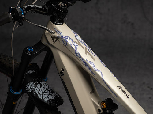 Lightning e-bike protector with fine lightning lines on a cream e-bike downtube